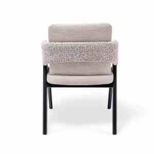 Silla Versa tapizada en tela clara con estructura negra, diseño moderno con respaldo acolchado y brazos integrados