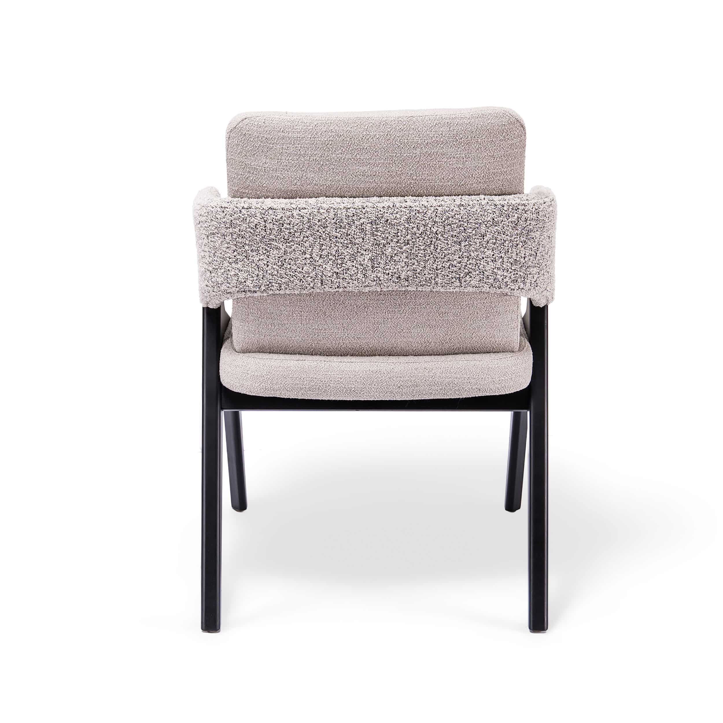 Silla Versa tapizada en tela clara con estructura negra, diseño moderno con respaldo acolchado y brazos integrados