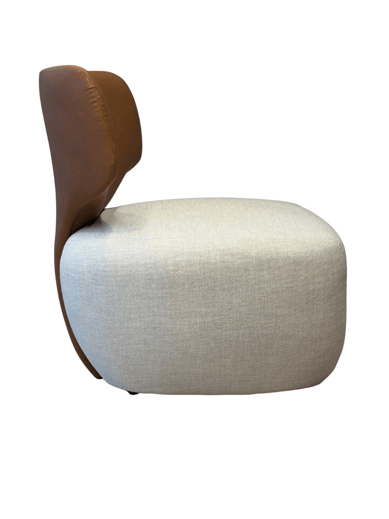 Poltrona Charlotte vista lateral con asiento tapizado en tono claro y respaldo en cuero color marrón
